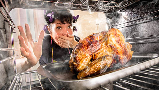 woman looking at burnt turkey