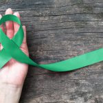 A green ribbon representing Mental Illness Awareness Week