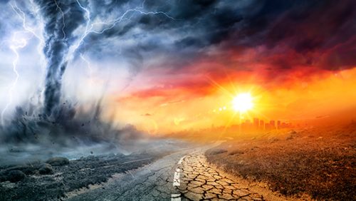 image is an intense scene of natural disasters. A chaotic tornado with lighting tears through he scene on the left. the scene then has a road that leads to a city on the horizon with a brilliant orange setting sun that juxtaposes the lighting storm