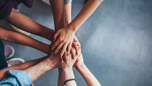 Image of hands coming together like a team work affirmation.