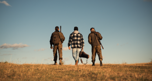 a group of people walking to go hunting