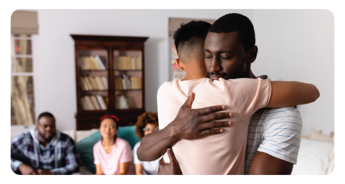 Child embraces father.