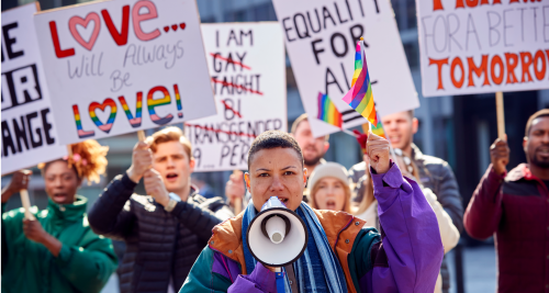 group of people protesting at a pride march.