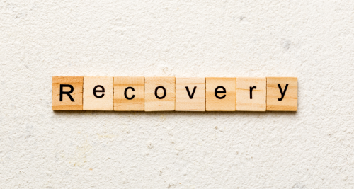 "Recovery" spelled out on wooden tiles